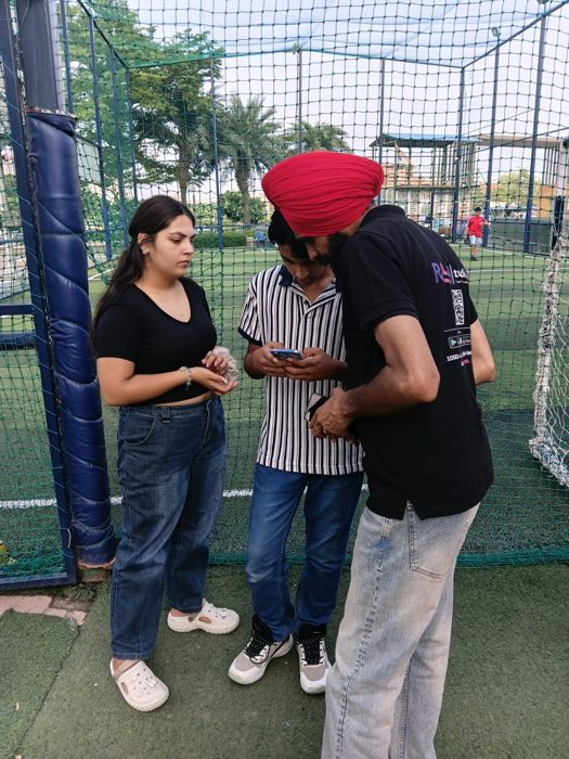 RAYY team member helping venue staff with the app on a phone