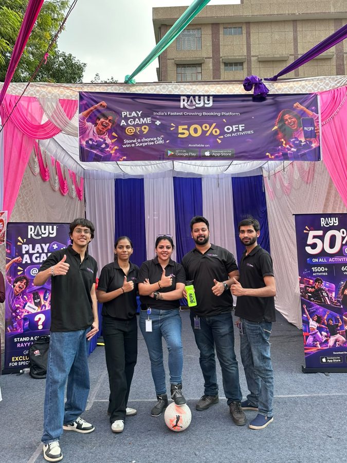 RAYY team at the RAYY stall with a "Play a game" banner